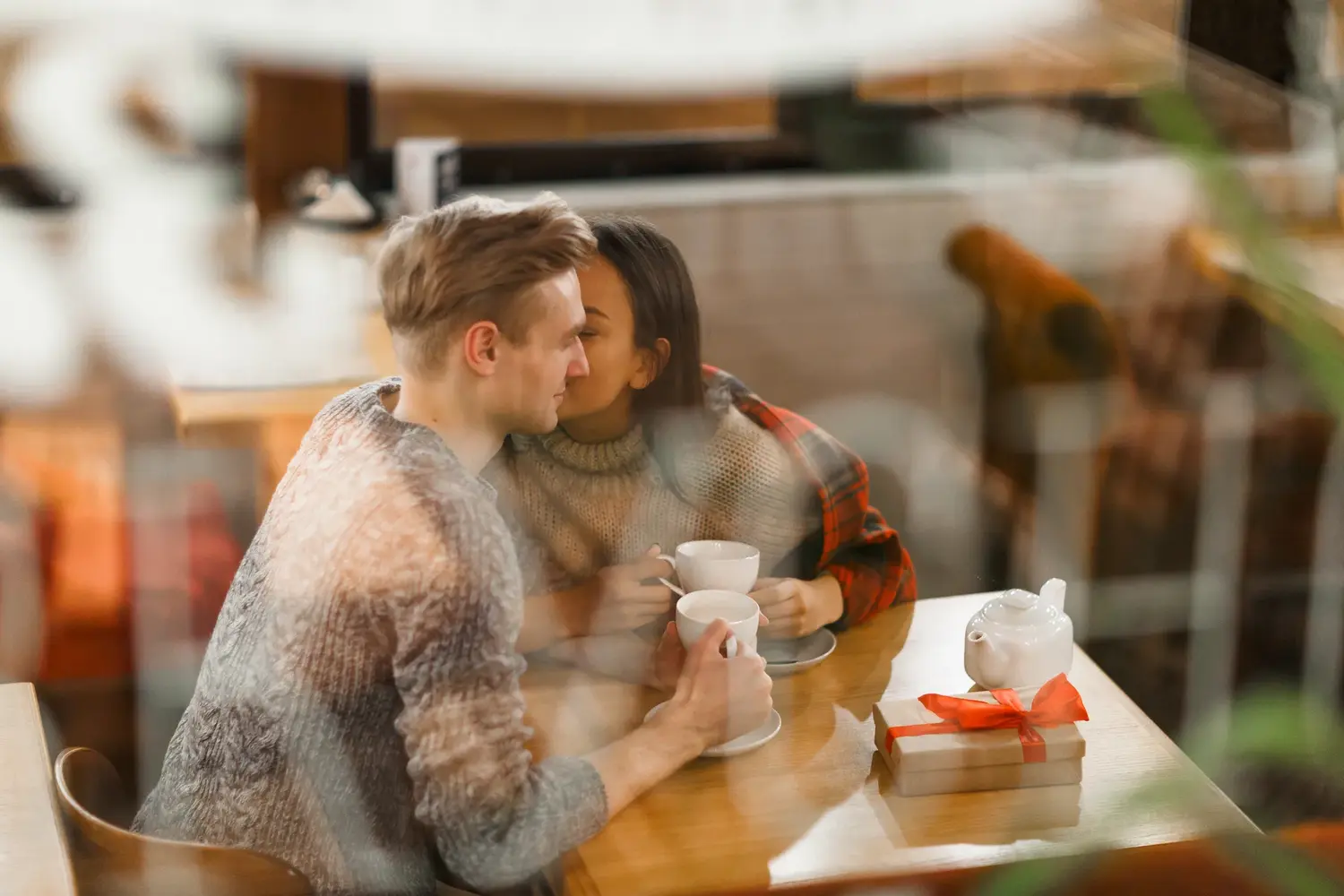 Couple sharing coffee at a small café table