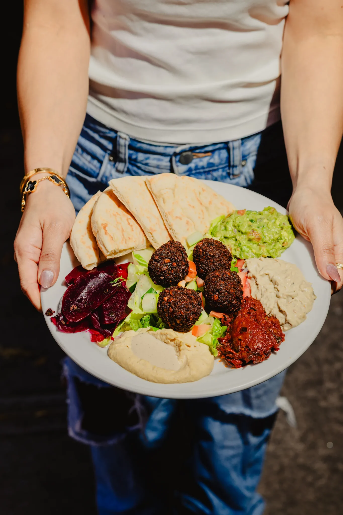 Falafel platter with hummus, pita, salad, and guacamole at Effy’s Café