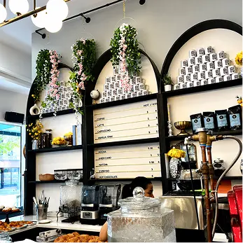 Interior of Effy’s Café with arched shelves and hanging plants