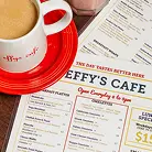 Coffee served on a red saucer at Effy’s Café