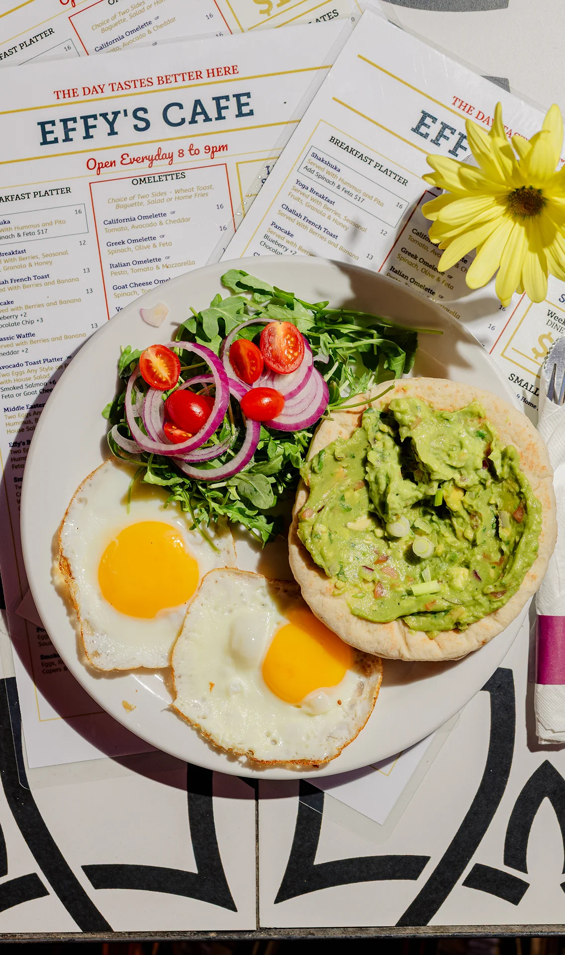 Fried eggs with avocado toast and arugula salad at Effy’s Café