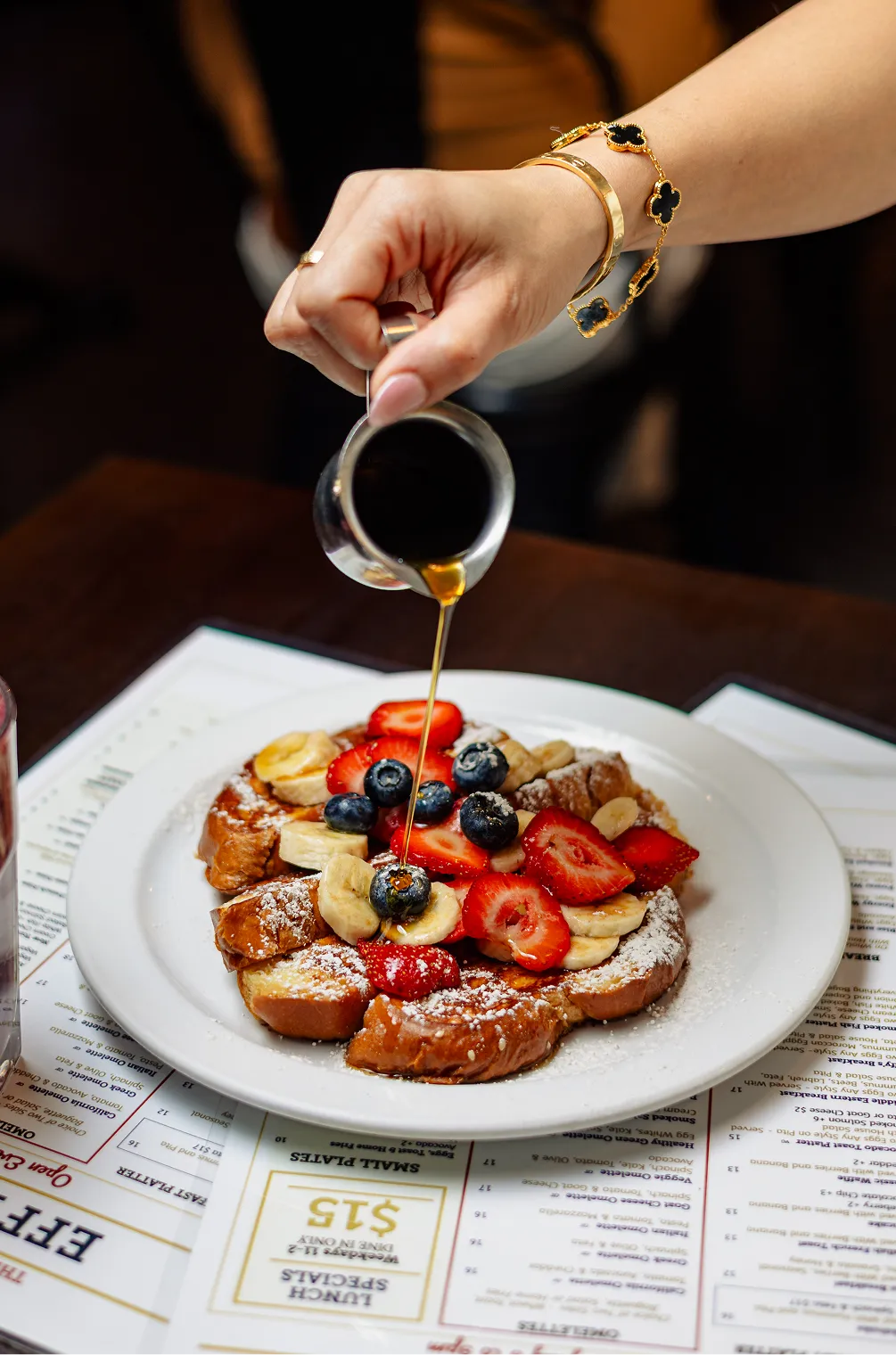 French toast topped with strawberries, blueberries, bananas, and maple syrup at Effy’s Café
