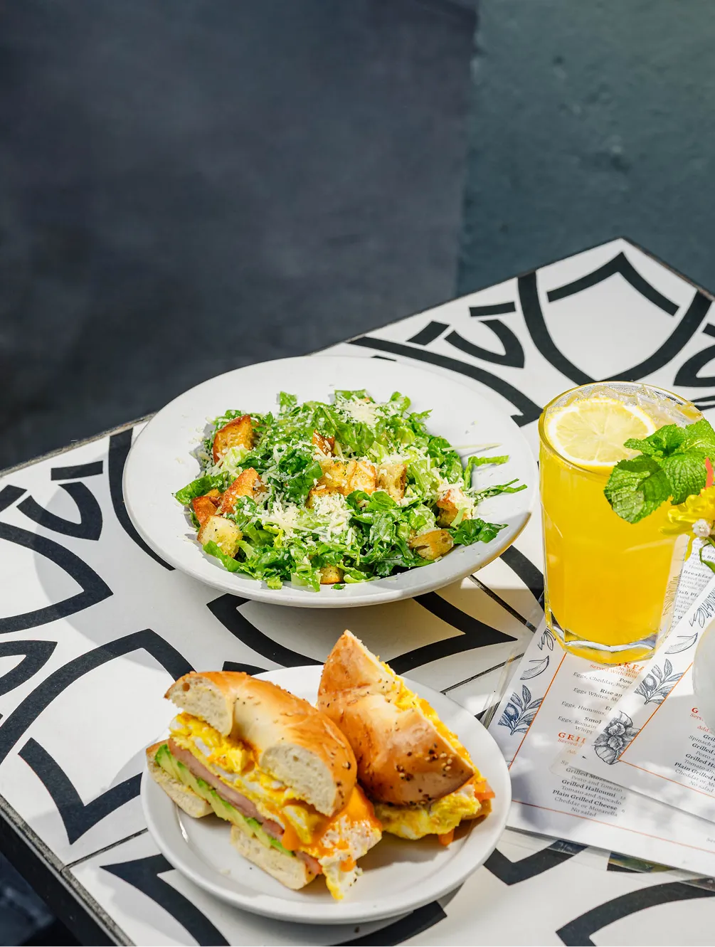 Egg and avocado bagel sandwich with green salad and a lemon mint drink at Effy’s Café